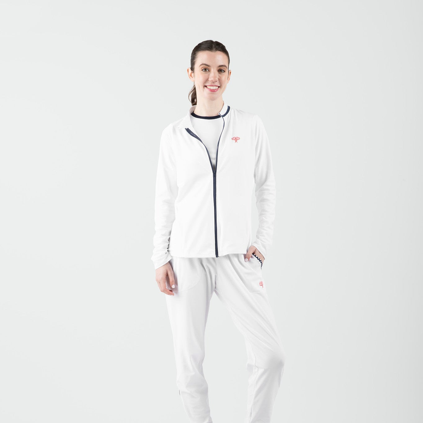 Person wearing a white outfit with a logo on a light gray background