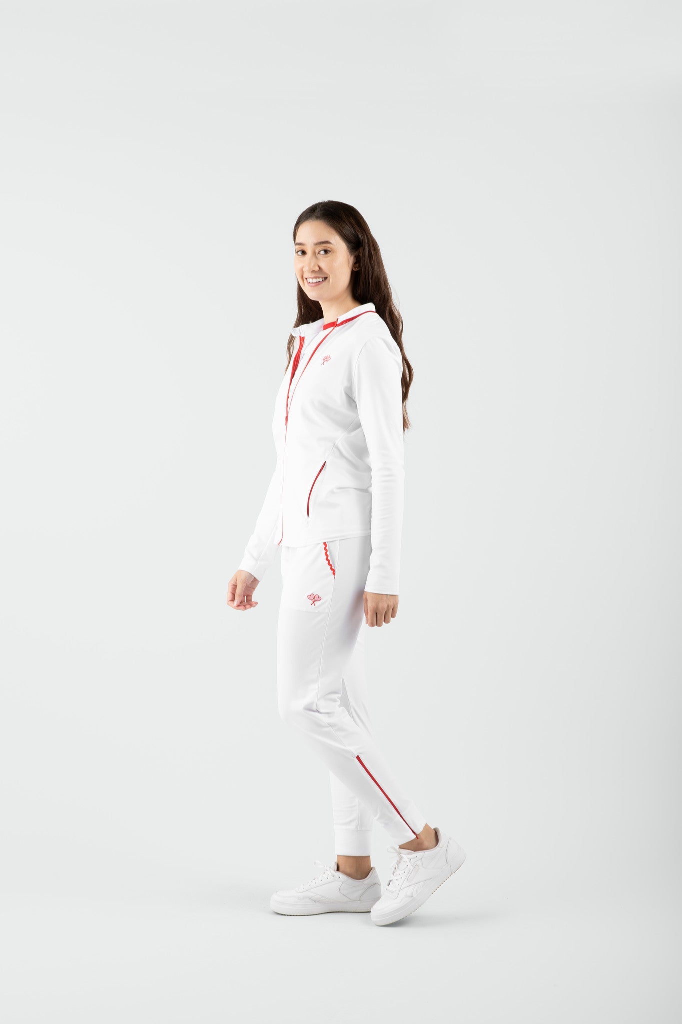 Person wearing a white pants with red accents on a white background