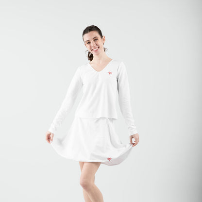 Woman wearing a white dress on a plain background