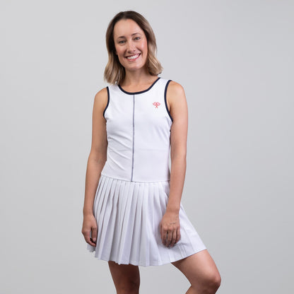 Woman wearing a white tennis dress on a gray background