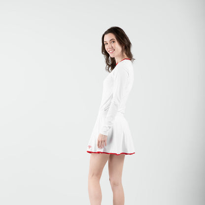 Woman in white and red tennis outfit on gray background