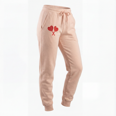 Peach sweatpants with a heart design on a white background