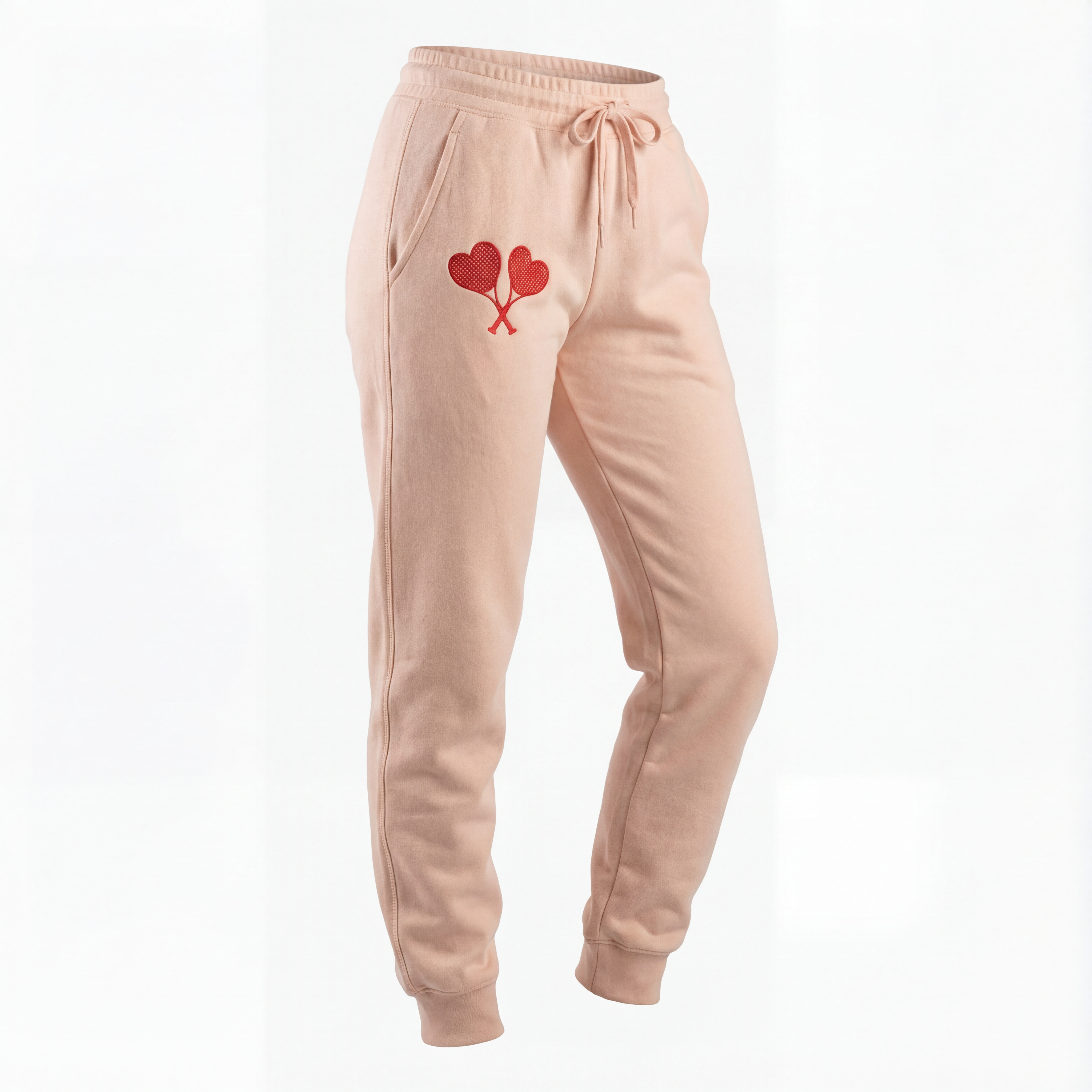 Peach sweatpants with a heart design on a white background