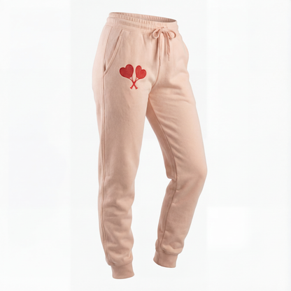 Peach sweatpants with a heart design on a white background