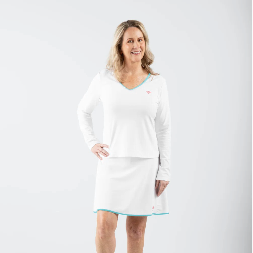Woman wearing a white outfit with a blue trim on a white background
