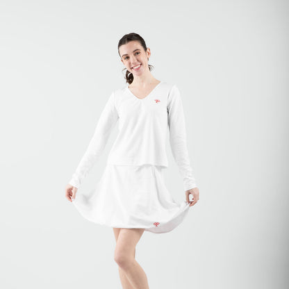 Woman wearing a white dress on a plain background