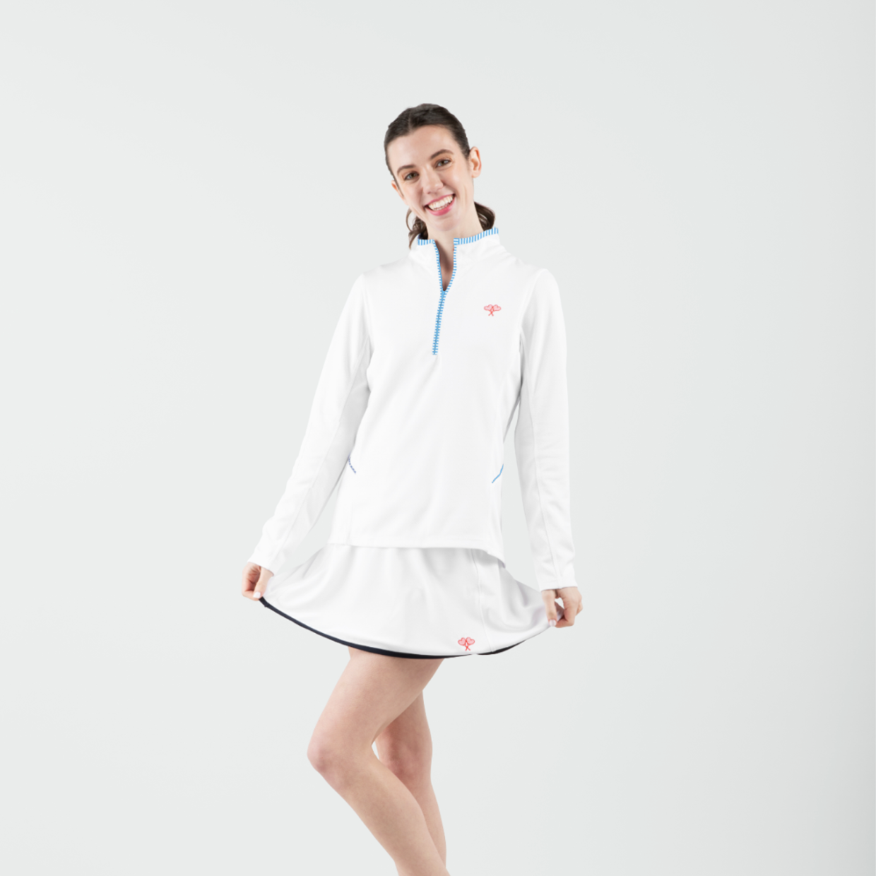 Woman wearing a white dress with a blue collar on a white background