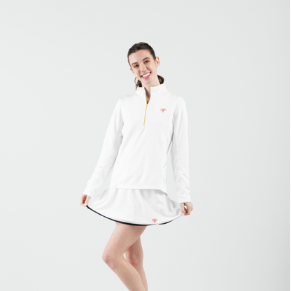 Woman wearing a white top and skirt with a logo on a light gray background