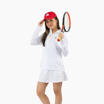 Person wearing a white outfit with a red cap and holding a tennis racket on a white background