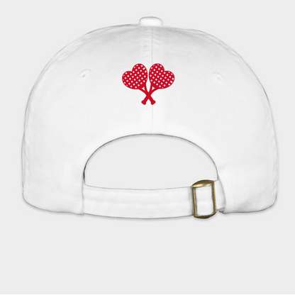 White cap with red heart design on a light gray background