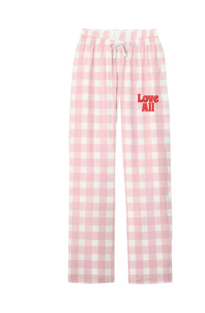 Pink and white plaid pajama pants with red "Love All" on the leg shown on a flat white background