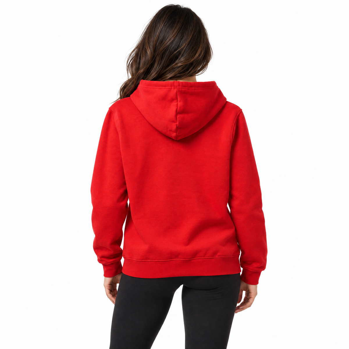 A woman viewed from the back wearing a bright red pullover hoodie and black pants against a plain white studio background.