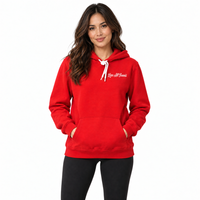 A woman modeling a bright red pullover hoodie with white drawstrings and white script text on the left chest that reads 'Love all Tennis'. She is wearing black leggings against a plain white studio background.