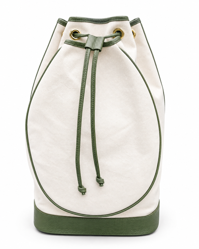 An off-white canvas bucket bag with olive green leather trim, drawstring, and base, featuring gold-tone eyelets.