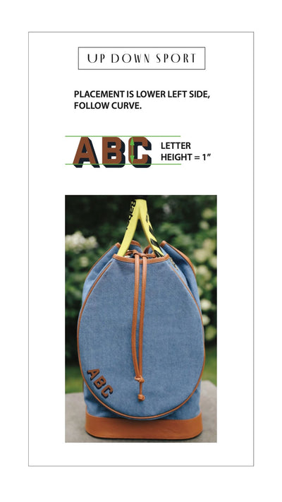 A product placement graphic for a blue canvas drawstring bag with tan leather trim and yellow handles. The graphic includes text reading 'UP DOWN SPORT', placement instructions, and a large 'ABC LETTER HEIGHT = 1"' with the bag shown below as an example of the customization.