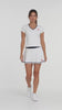 Video showing woman in white tennis outfit with navy blue trim and white sneakers